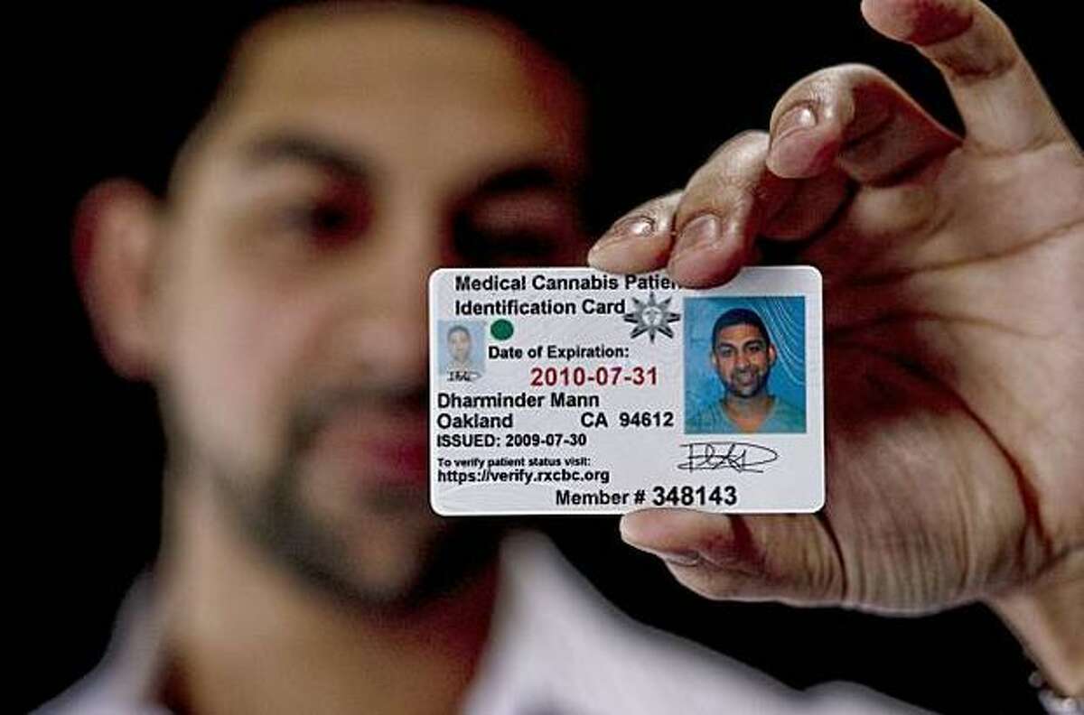 Dhar Mann, owner of iGrow, shows his official medical cannabis card.
