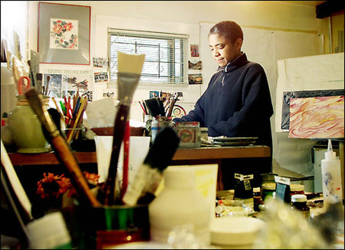 Seattle artist Barbara Earl Thomas, at work in her studio, says of the nation's dependence on imported oil: "I'll park my car before I send your kid overseas."