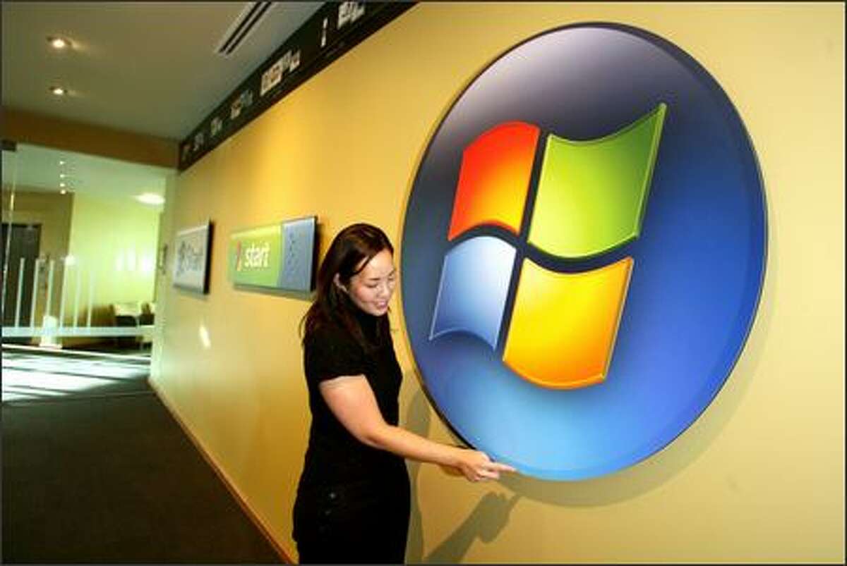 Jenny Lam, creative director for Windows User Experience, adjusts an oversized version of the Windows Vista "Start" button -- which no longer says "Start."