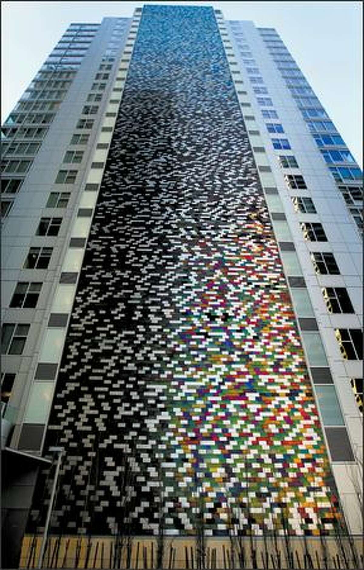 On the south side of the 5th and Madison tower rises a colorful, 250-foot-high ribbon of stainless steel shingles.