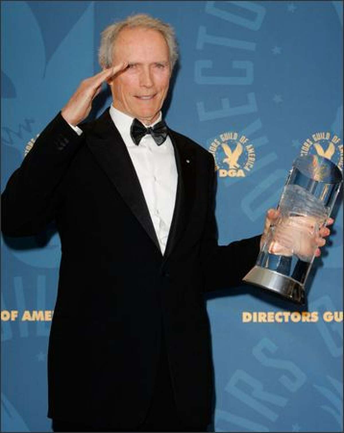 Clint Eastwood salutes backstage as he poses with the Directors Guild of America lifetime achievement award at the 58th Annual Directors Guild Awards in Los Angeles, on Saturday, Jan. 28, 2006. (AP Photo/Mark J. Terrill)