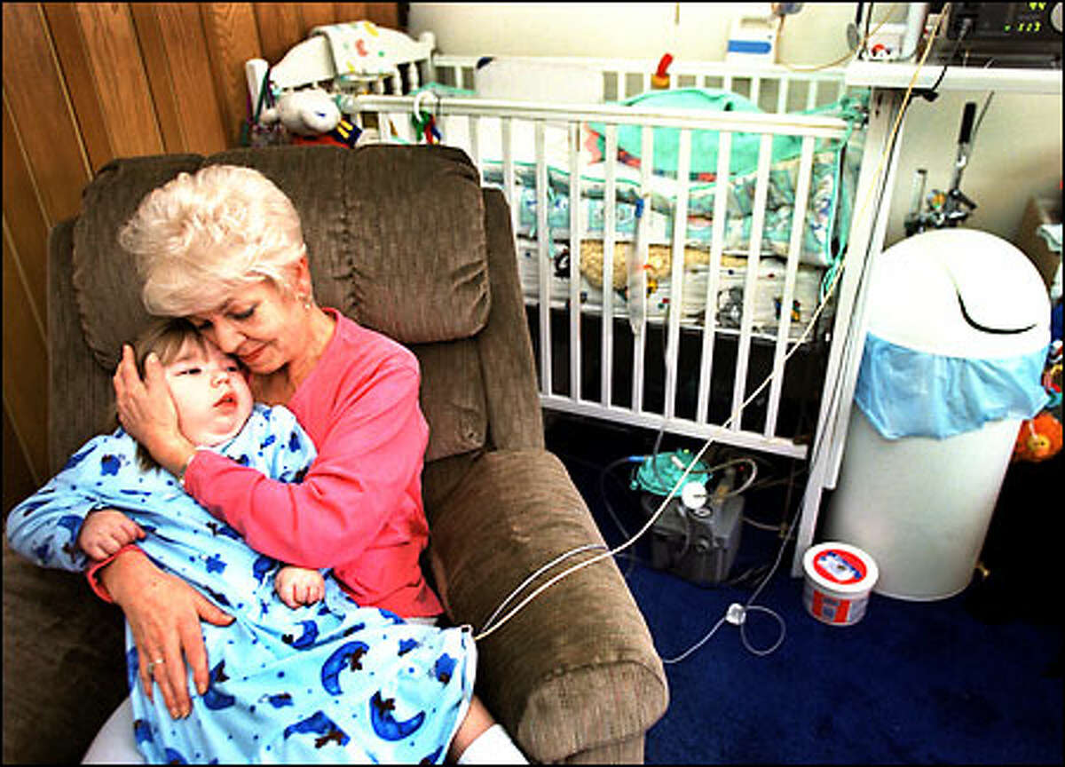 Chelsea Porter is held by her grandmother, Barbara Porter, in her home in Lynnwood. At 4 years of age, the profoundly brain-damaged child still sleeps in a crib.