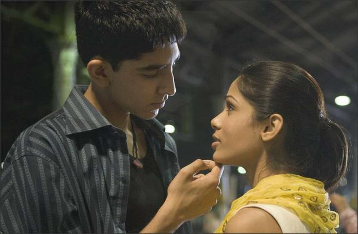Dev Patel, left, and Freida Pinto are shown in a scene from "Slumdog Millionaire."