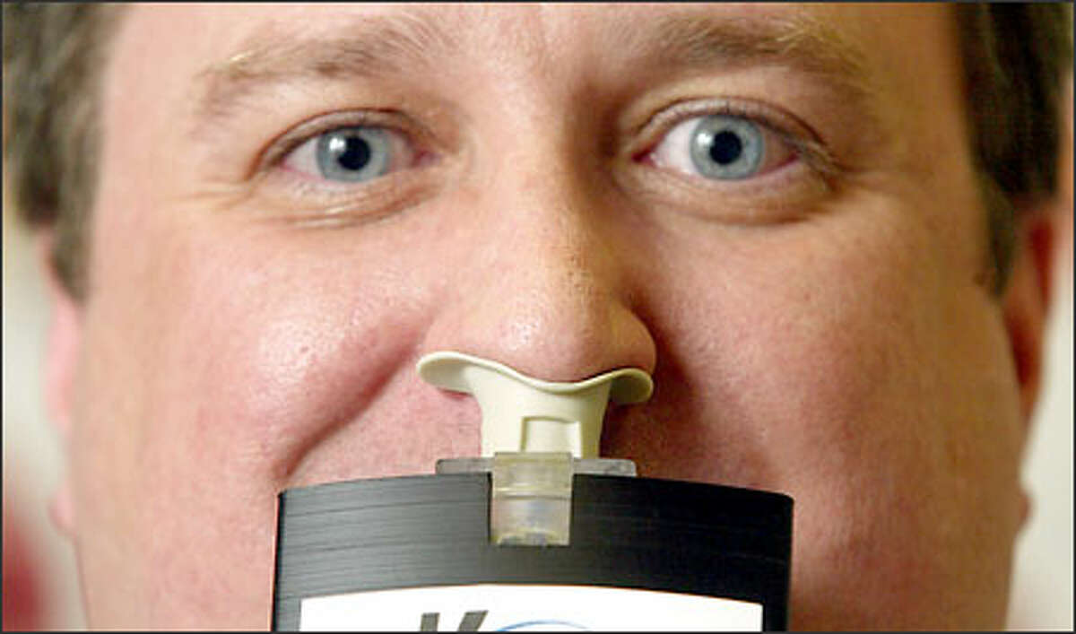 Marc Giroux, chairman and CEO of Kurve Technology, demonstrates his company's nasal drug delivery device yesterday. Giroux invented the "ViaNase" after suffering sinus problems for 30 years.