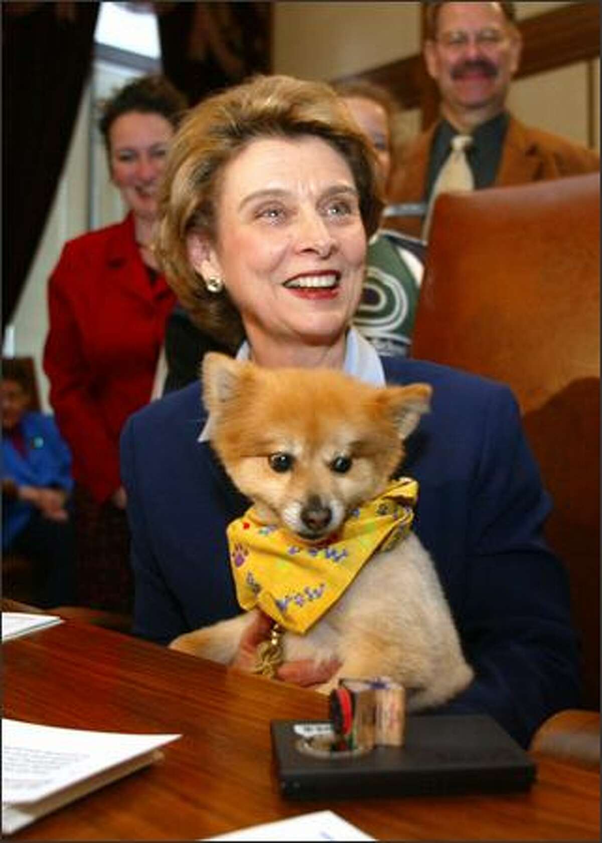 Gov. Chris Gregoire holds"first dog" Franz, a Pomeranian, after signing a bill creating a "We Love Our Pets" auto license in Olympia Wash., on April 18, 2005.