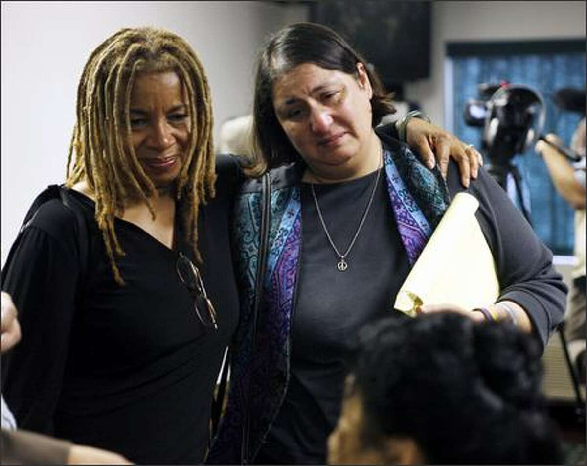 Margaret Prescod, with the Global Women's Strike, left, and Liz Rivera Goldstein, campaign coordinator of Friends and Families of Lt. Watada, listen to interviews at a news conference held in DuPont after the mistrial.