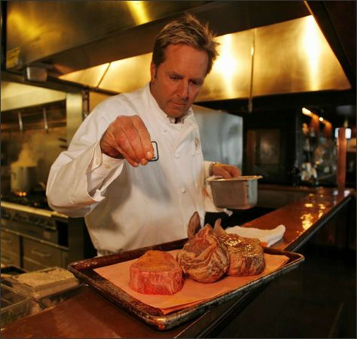 Executive chef Bradley Dickinson prepares a pair of "tomahawk chops" and a Delmonico steak at Daniel's Broiler at Leschi. Every cut is USDA prime beef, down to the delicious filet mignon steak strips appetizer.