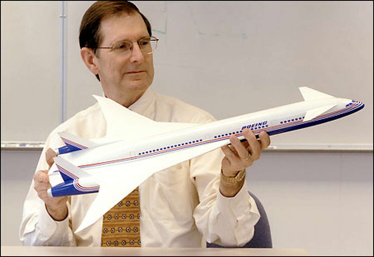 Walt Gillette, vice president and general manager of the sonic cruiser program at Boeing, displays a model of the plane, which could be an evolutionary leap in airline transportation.