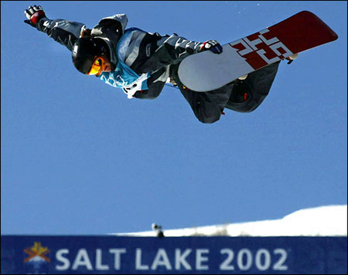 American Kelly Clark shows her form during the women’s snowboarding halfpipe competition yesterday in Park City, Utah. The 18-year-old from Vermont soared higher than any of her competitors and easily won the first gold medal of the Games for the United States.