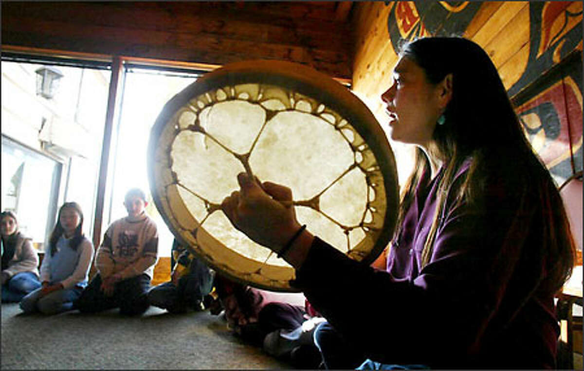 Chenoa Egawa, a Lummi and S'Klallam Indian singer and storyteller, sings a song to fifth-graders from Highlands Elementary in Renton at Ivar's Salmon House. Yesterday's program was part of "Salmon in the Classroom," in which students are taught the cultural link between salmon and Native Americans of the Northwest. Ivar's hosted the state Department of Fish and Wildlife program for the students. They had to write Indian legends to qualify. "With the legend writing, we were able to incorporate language-arts curriculum into this science program," teacher Erica Anderson said.