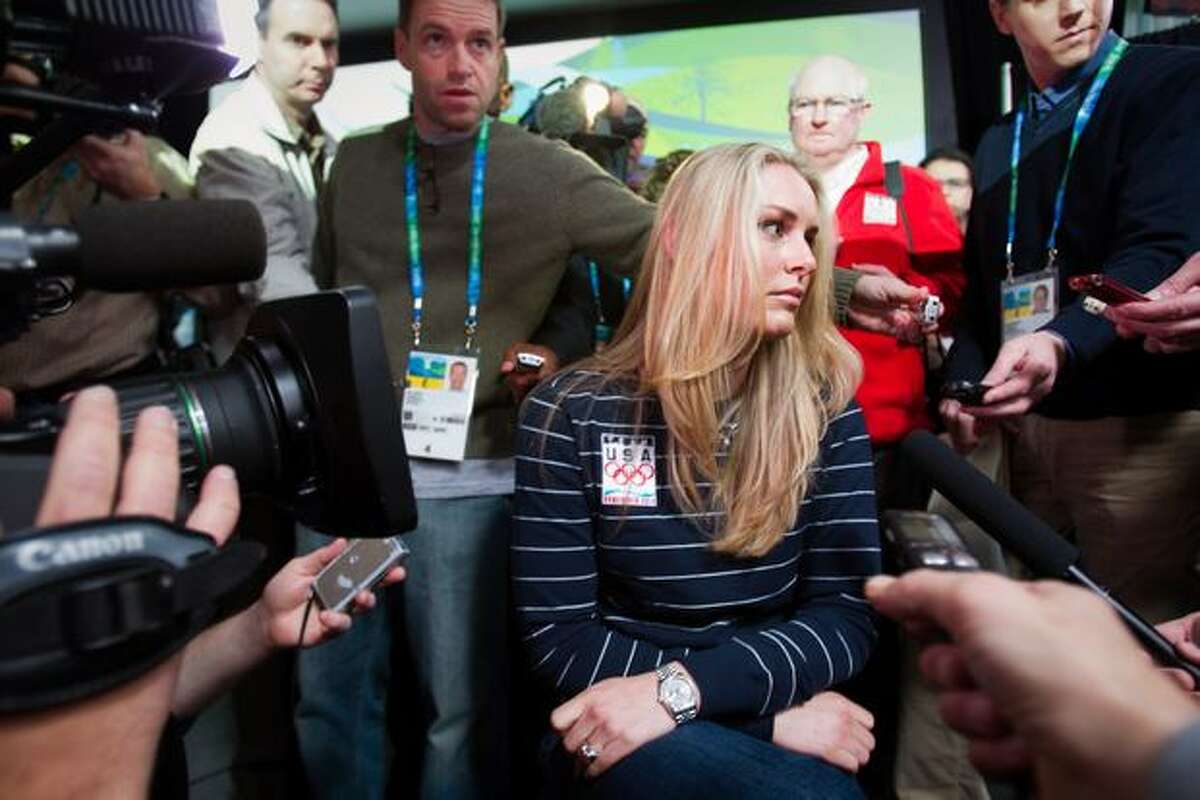 US alpine skier Lindsey Vonn is surrounded by media during a news conference in advance of the 2010 Winter Olympic Games on Wednesday, Feb. 10, 2010, in Vancouver. Vonn revealed that she sustained a shin injury in training that puts her participation in the games in question.