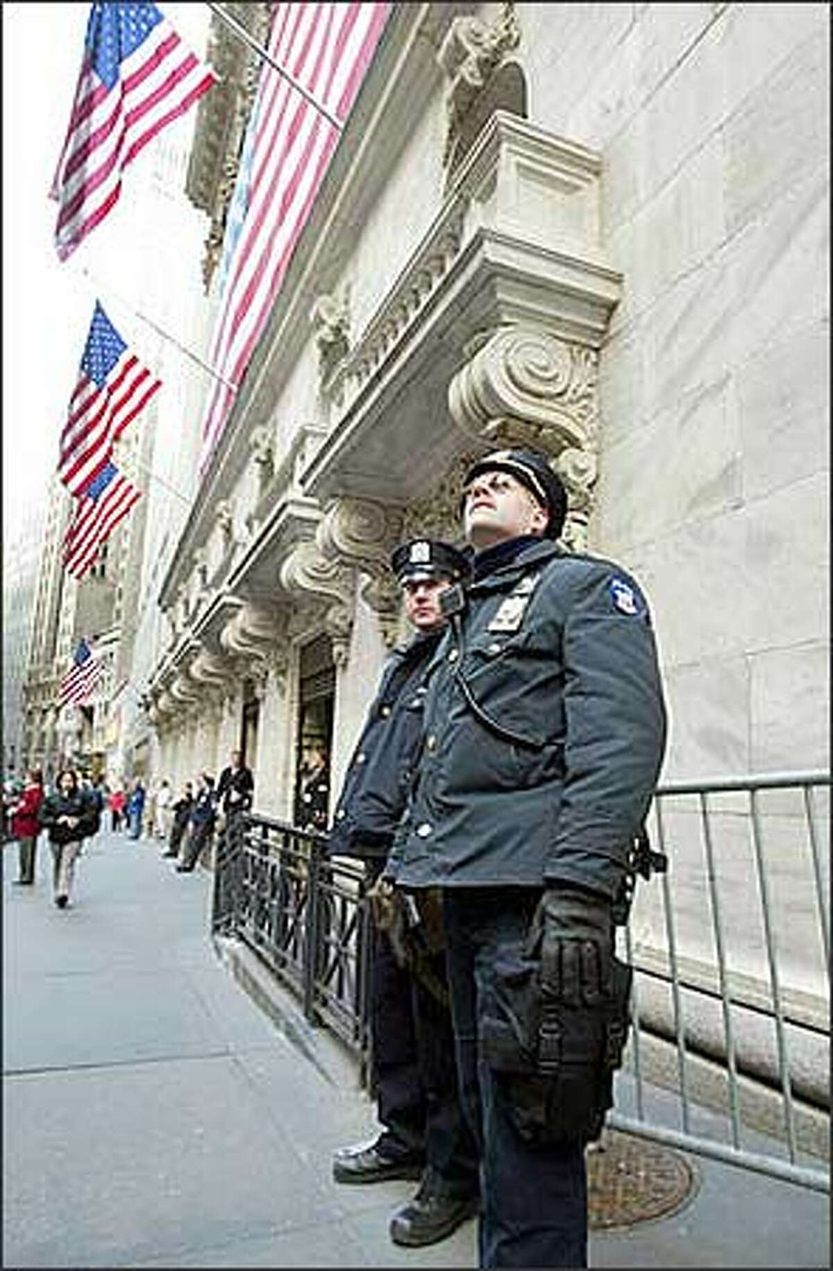 Police patrol outside The New York Stock Exchange Wednesday, Feb. 12, 2003. Police stepped up security at airports, subways and hotels and other public places after the nation was put on heightened terrorist alert and law enforcement officials indicated New York was a possible target. (AP Photo/David Karp)