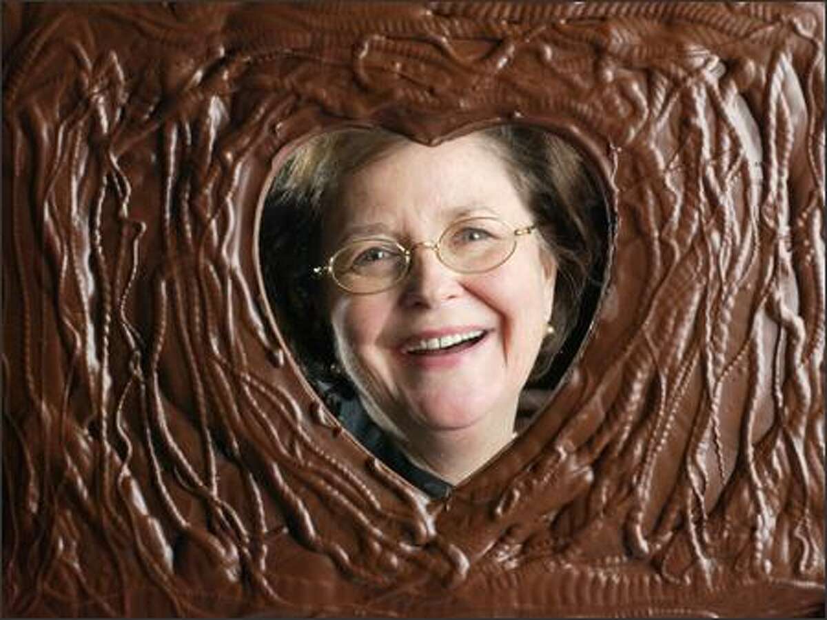 Fran Bigelow, president of Fran's Chocolates, is seen through a Valentine's Day-themed confection.