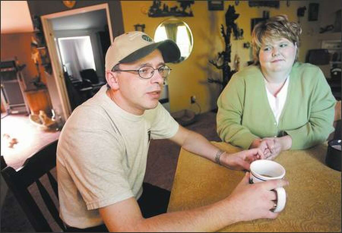 Amnesia victim Jeff Ingram, left, talks during an interview as his then girlfriend Penny Hansen sits beside him at her home Thursday in Olympia. The couple were married on Dec. 31.