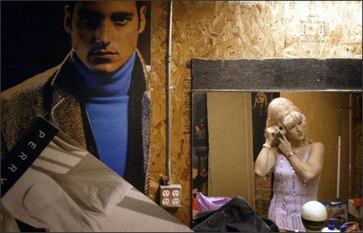 Mark Finley, aka Mama Mark, adjusts his wig in the basement dressing room of Neighbours Disco after a performance in the Capitol Hill club recently.