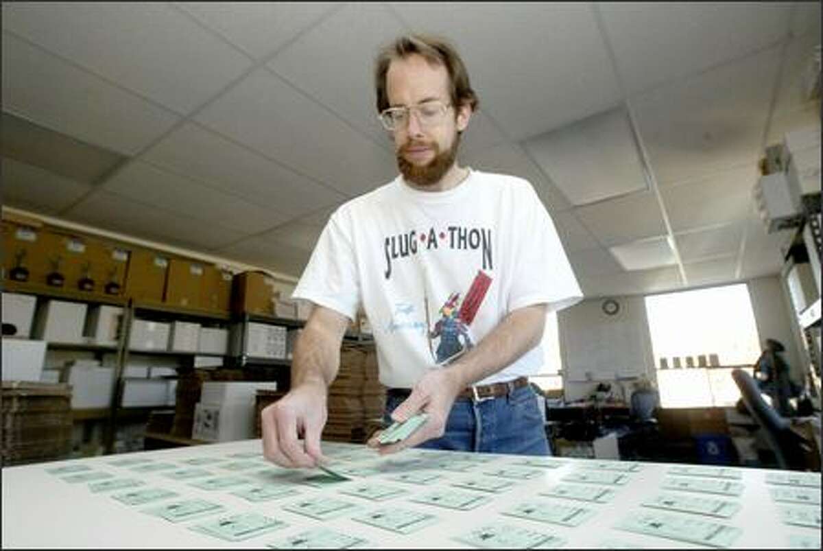 Toivo Rovainen collates game cards at the Cheapass Games office in Ballard. The company's games are sold nationwide.