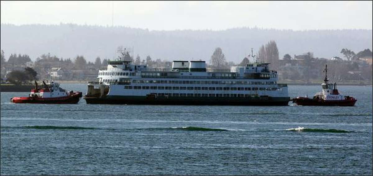 The Hyak is taken from Seattle by tugboat Wednesday after developing mechanical problems.
