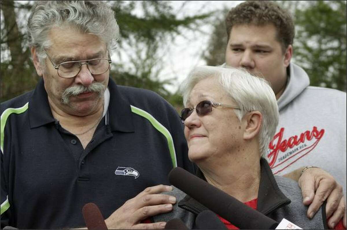 Jim and Lynn Morris, parents of Rebecca Shaw, talk to the media about their daughter outside their Maple Valley home on Friday. In the background is Shaw's brother Billy Morris. Shaw, 24, was the first officer on Flight 3407, the Colgan Air flight that crashed Thursday nigth in suburban Buffalo, killing all 49 aboard and one person on the ground.