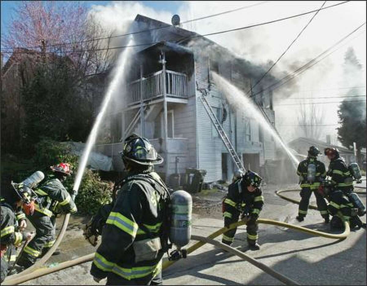 Seattle firefighters extinguish a fire that gutted a small apartment building in Seattle's Eastlake neighborhood.