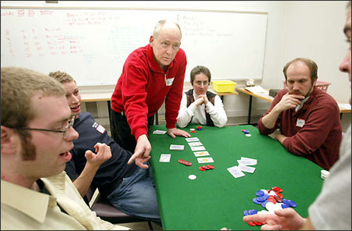 Larry Zeldner gives his students pointers on getting the pot straight during a tournament on the final night of poker class at the UW.