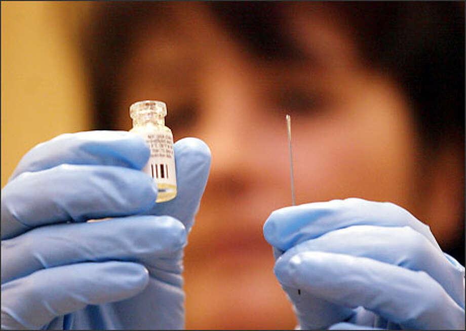 A vial of smallpox vaccine and the needle used to administer it are displayed by Marnie Marvin, with the Clark County Health Department, at Camp Murray on Fort Lewis. Photo: Mike Urban, Seattle Post-Intelligencer / Seattle Post-Intelligencer