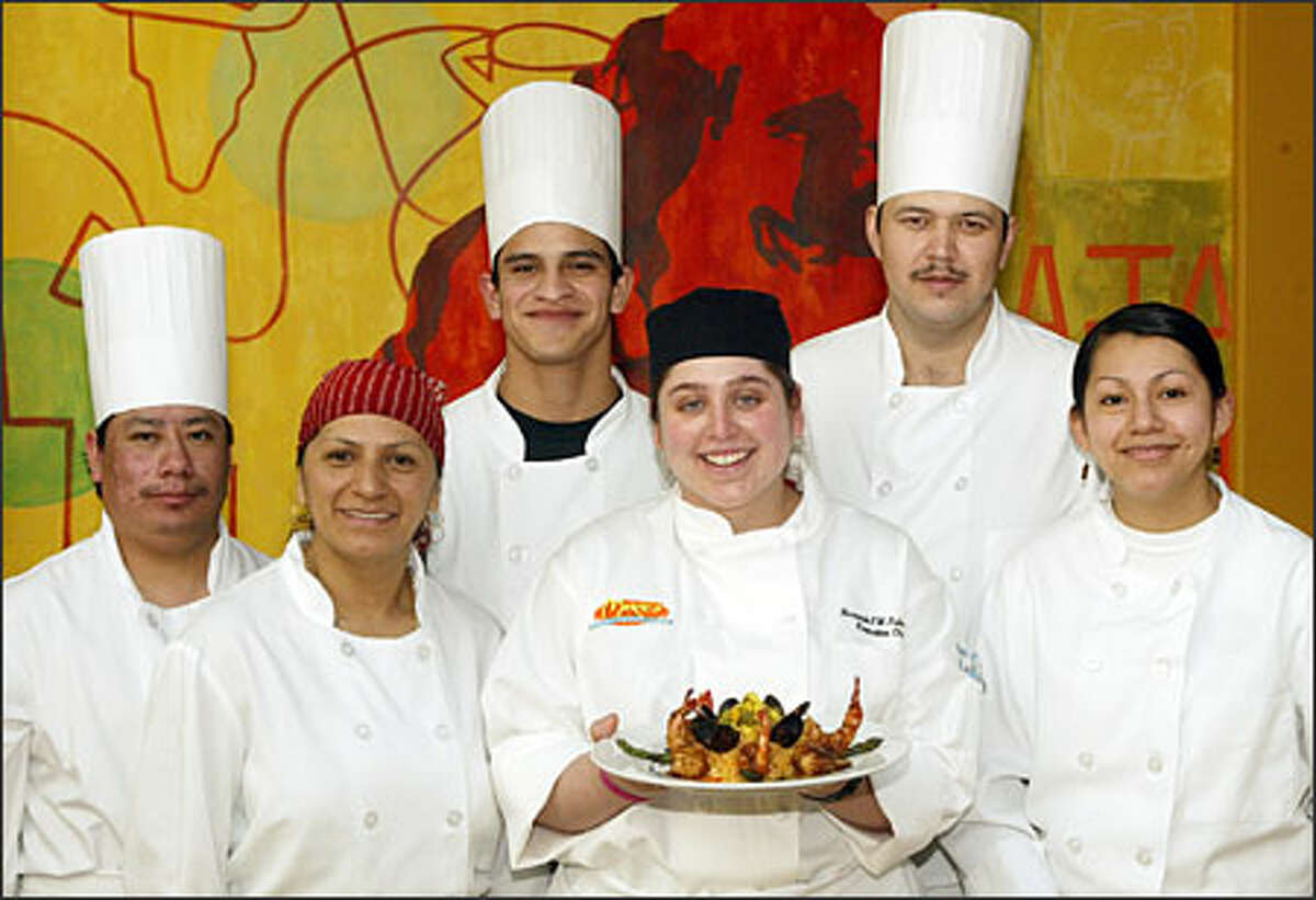 Sparks of originality are in dishes like Mariscos Jarochos, held by chef Fernanda Fulkerson. Her staff includes Erasmo Gomez, Eva Mota, Oscar Garnica, Juan Lopez and Heydi Jimennez.