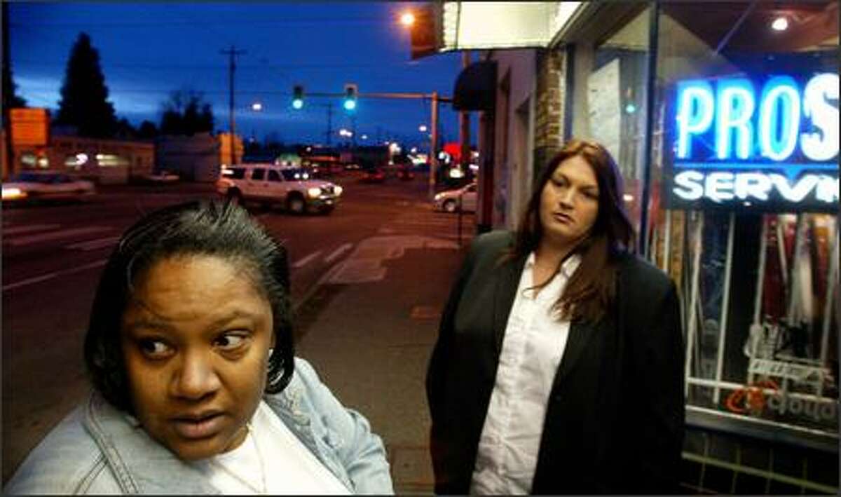 Social worker and ex-prostitute Nature Carter-Gooding, left, walks Aurora Avenue North to offer prostitutes help giving up the life. With her is recruit Tomi Whittington.