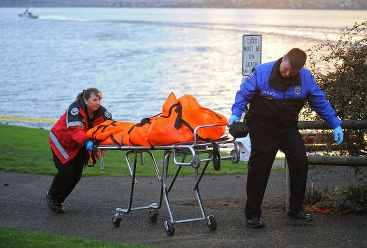 The body of a man who was discovered in Lake Washington floating 15 yards offshore from Marsh Park in Kirkland is taken away from the dock Saturday evening Feb. 27, 2010.