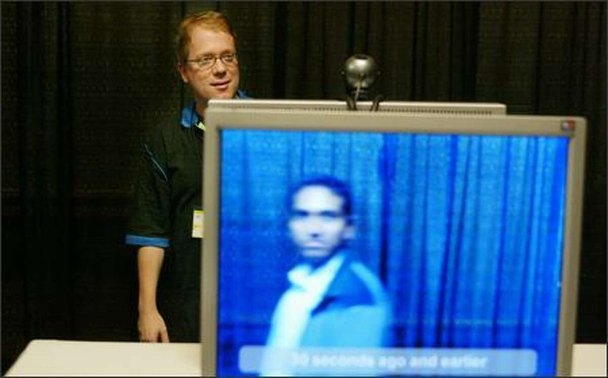 Microsoft's Andy Wilson shows a virtual "mirror," which records and analyzes an image and then displays similarly dressed or appearing people or things.