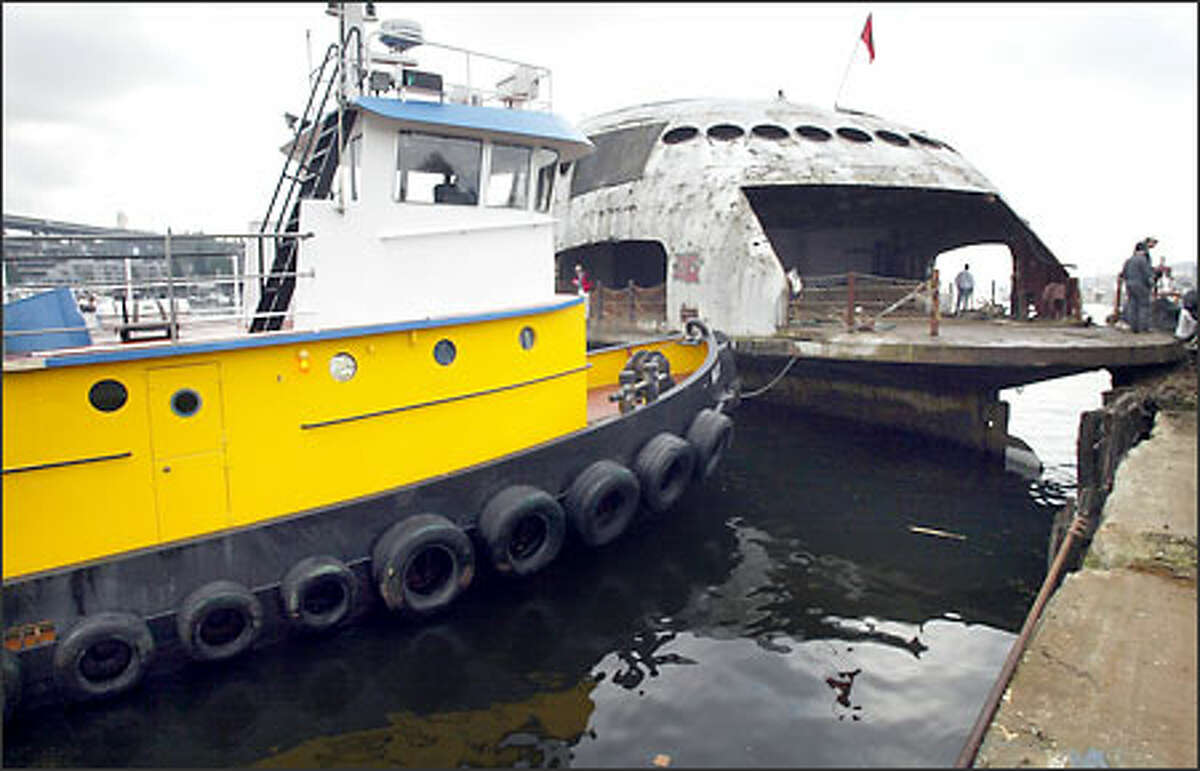 The tugboat Wasp waits to push off the 1930s-era ferry from moorage on Lake Union.