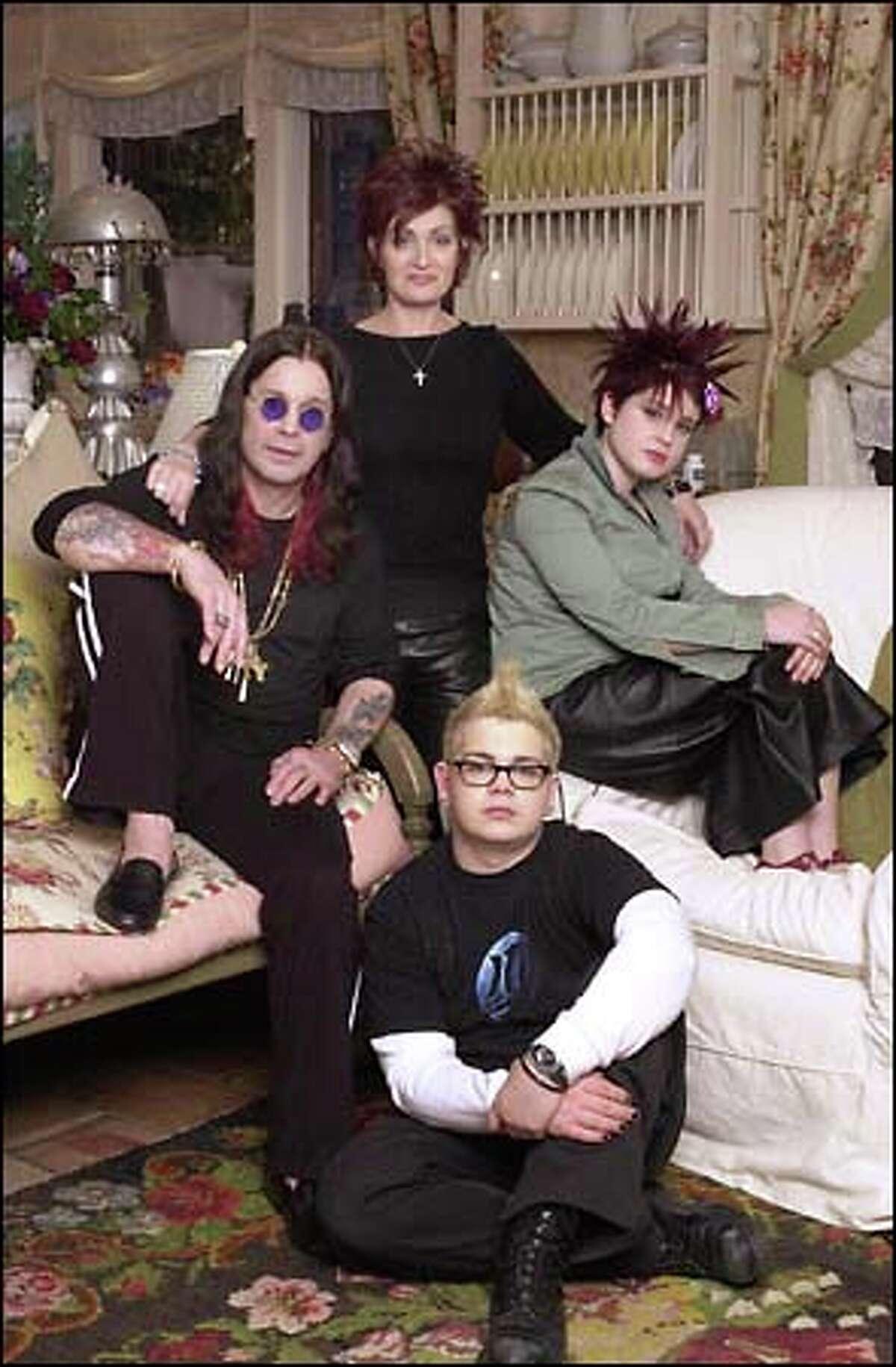 With a whole lotta (bleeping) going on, MTV chronicles the daily existence of a rock 'n' roll family in "The Osbournes," featuring Ozzy Osbourne, left, wife Sharon, standing, daughter Kelly and son Jack. In this household, the f-word is just another parenting tool.