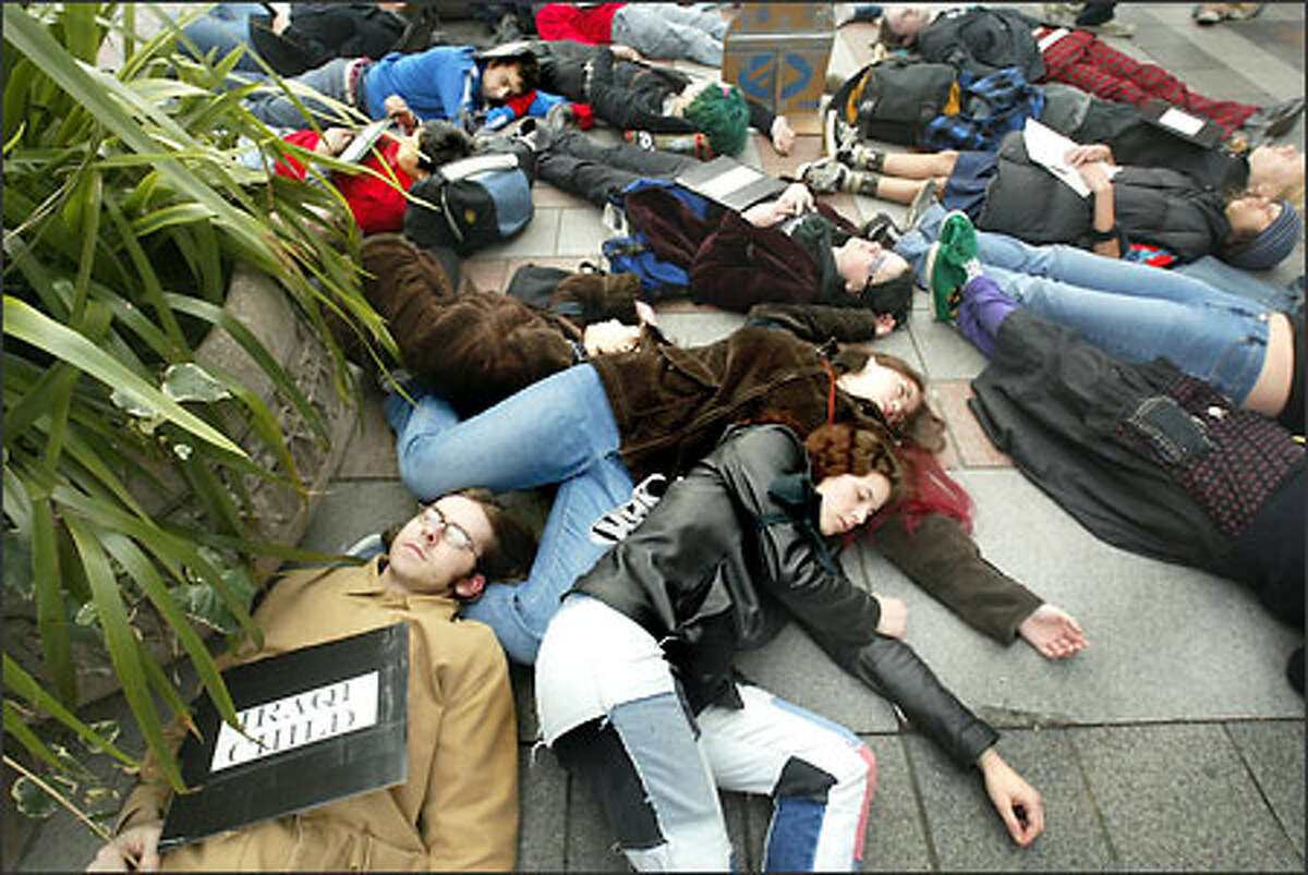 Students from Seattle area public schools and colleges stage a "die-in" on the sidewalk outside the Westlake Center downtown to portray victims of a potential U.S. attack on Iraq.