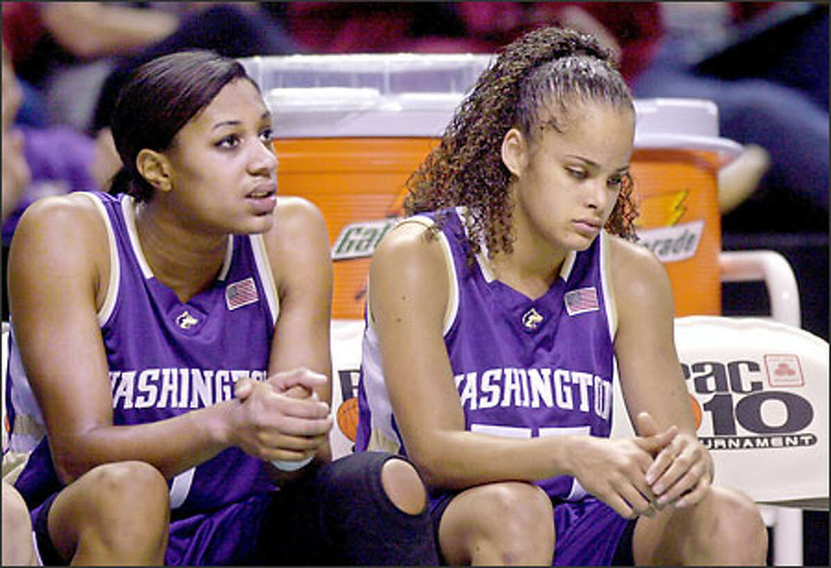 Forward Jill Bell, left, and guard Cameo Hicks watch the final minutes of their 77-55 semifinal loss to Arizona in the Pac-10 tournament. The Huskies still hope for an NCAA Tournament at-large berth.
