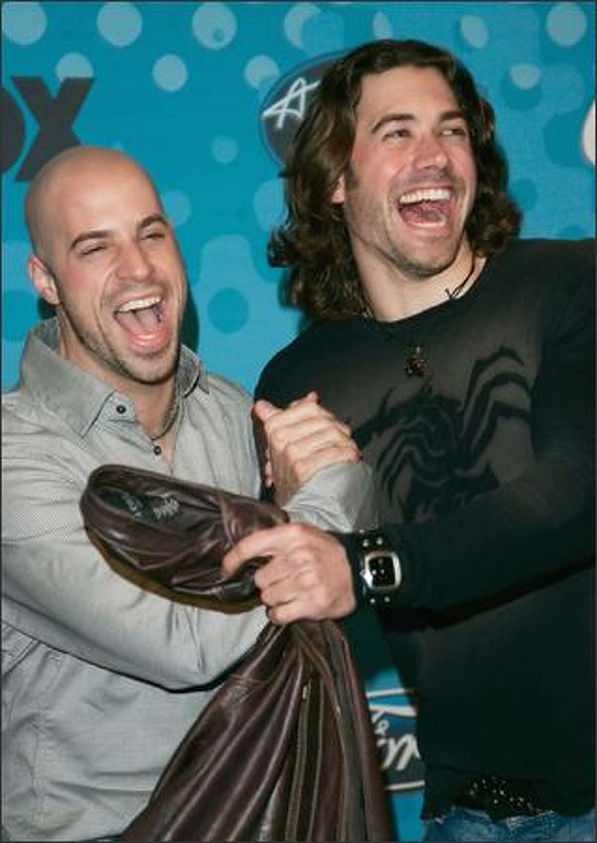 "American Idol" contestants Chris Daughtry, 26, and Ace Young, 25, are happy campers at the "American Idol" Final 12 Party in Hollywood on Thursday. The party included a reunion for season four contestants (and long-haired rockers) Constantine Meroulis and Bo Bice.