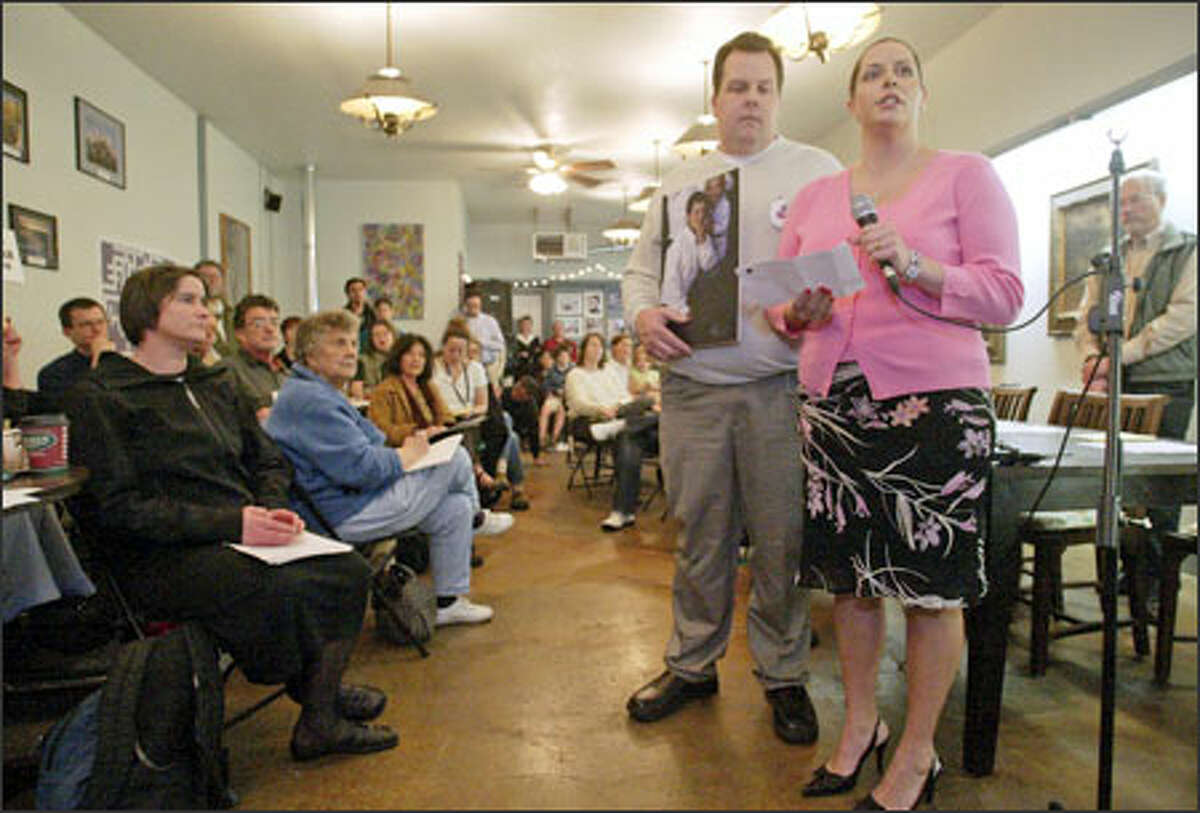 Eric and Jennifer Messenger, parents of Nick Messenger, address community members gathered at the Bizz Buzz Box coffeehouse in Crown Hill yesterday to discuss pedestrian safety. Their son was hit by a car at the intersection of Northwest 87th Street and 15th Avenue Northwest on Feb. 24 and is still in a coma. Jennifer Messenger thanked the community for its well wishes.