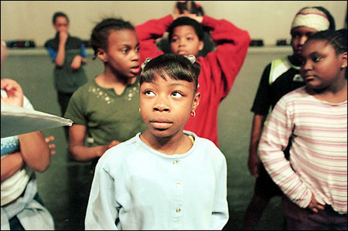 Students from Martin Luther King Jr. Elementary School including 5th grader Ashleigh Futrell, center, listen to PNB outreach director Phillip Otto. The children were practicing for this Sunday's Discover Dance Community Performance at the Seattle Center Opera House. The free event will include professional and student dancers from Pacific Northwest Ballet and 400 public school students from the Seattle and Bellevue areas.