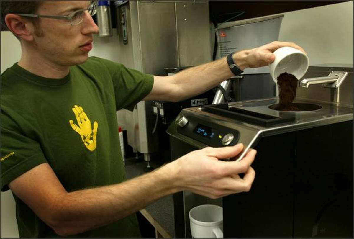Zander Nosler pours grounds into the Clover at The Coffee Equipment Co. Inc on Monday.