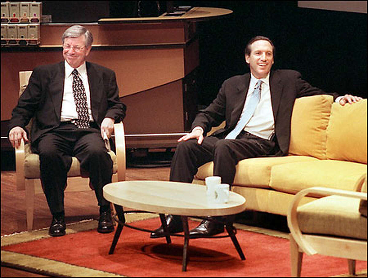 Starbucks Chairman Howard Schultz, right, and Chief Executive Orin Smith enjoy a light moment at yesterday's shareholders meeting.