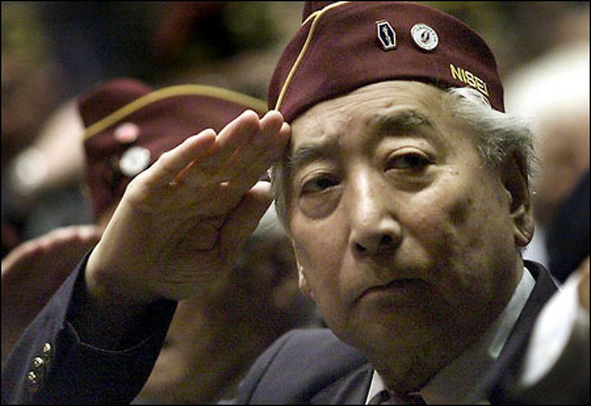 WWII Veteran Frank T. Matsuda of Company "H" salutes with fellow Washington Nisei who served as the Honor Guard for a Medal of Honor ceremony for Pfc. William K. Nakamura and Technician Fifth Grade James K. Okubo at the Mercer Center.
