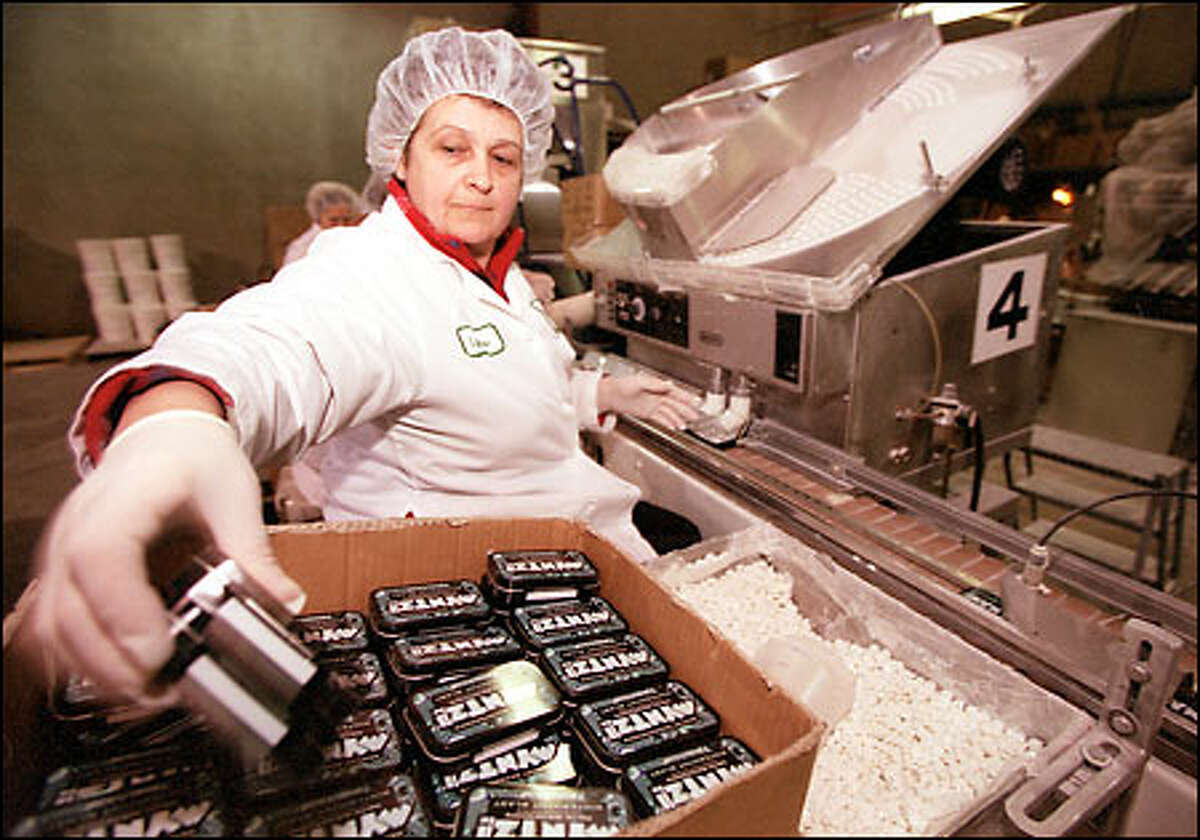Lyubov Nikityuk packages freshly made Myntz! candies at the Vitech America plant in Kent. The mint has sold well in a competitive Seattle market.