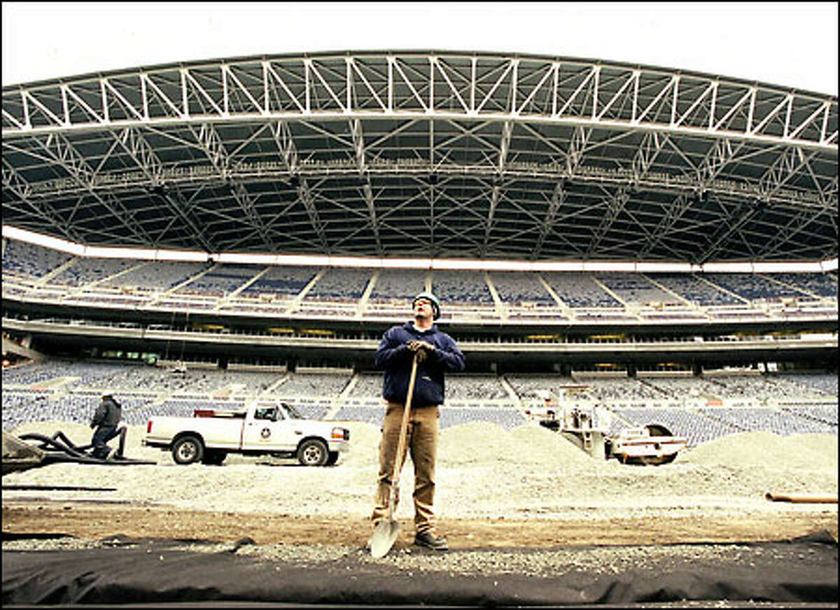 Gabriel Schoenfelder takes a break from shoveling gravel into an irrigation ditch in the center of the Seahawks’ new stadium in downtown Seattle. Construction of the stadium is in its final stages, and although the players like the new uniforms they’re getting, they’re more excited about their new home. “The neatest thing for us is this great stadium,” defensive tackle Chad Eaton said. “This thing is dynamite.”