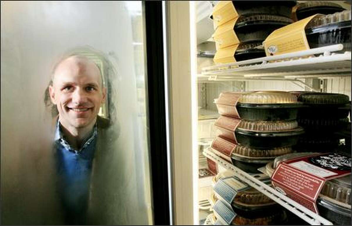 Greg Conner outside a freezer of entrees at Eat Local, his new business on Queen Anne Hill. Eat Local specializes in prepared meals that are made with ingredients, including organic meats and produce, that come from within a several-hundred-mile radius. Conner and a number of chefs collaborated on the 40-item menu.