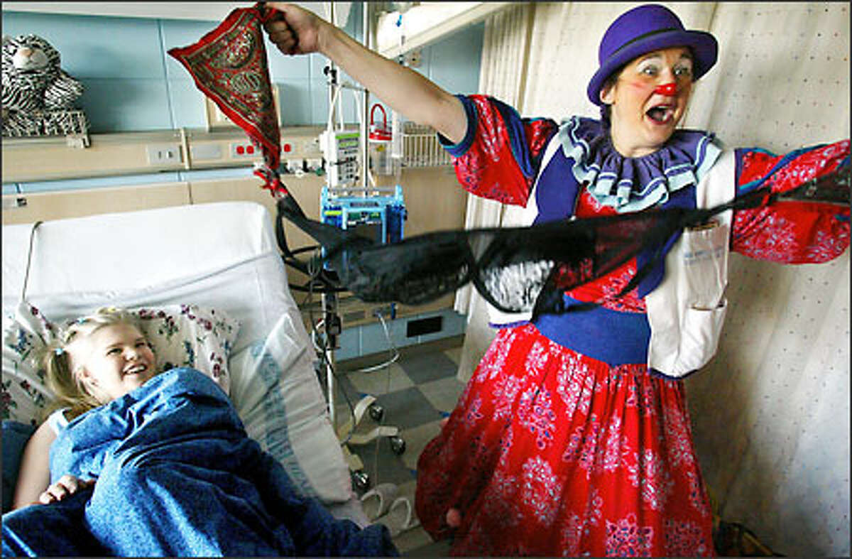 Although a hospital stay isn’t generally considered a whole lot of fun, 13-year-old Caitlyn Lingbloom, in her room at Children’s Hospital and Regional Medical Center, manages a laugh at the sudden appearance of some lacy undergarments in the hands of Dr. Le Fou (Victoria Millard). Dr. Le Fou, a clown with the Big Apple Circus Clown Care Unit, has entertained patients at Children’s for five years.