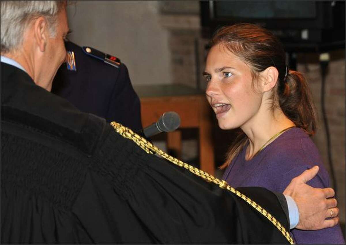 Amanda Knox talks to her lawyer, Carlo Della Vedova, during a hearing Saturday in the Meredith Kercher murder trial in Perugia, Italy.