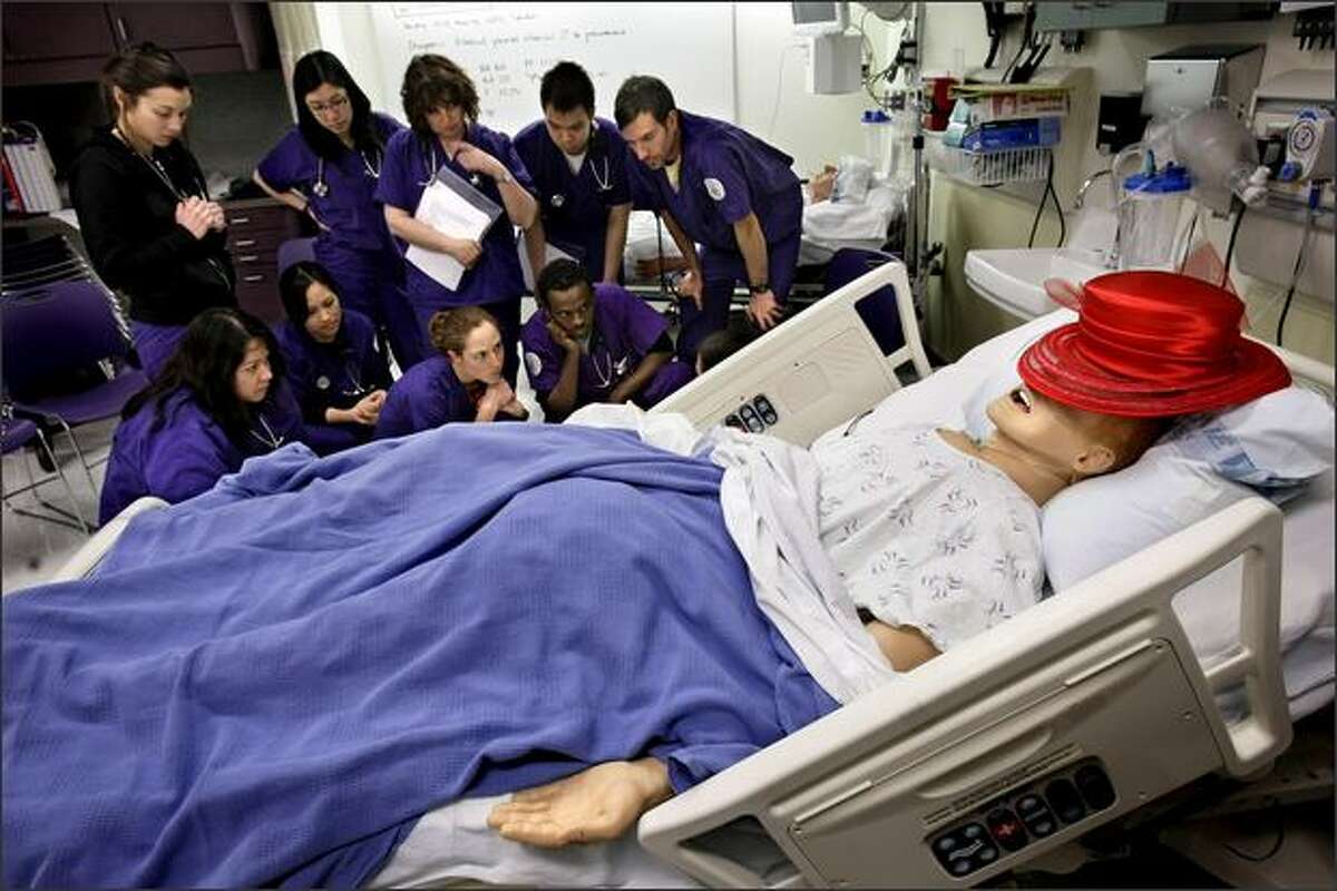 UW School of Nursing students learn how to check for leaks in chest tubes hooked up to SimMan, a computerized, simulated patient used in the school's hands-on training lab.
