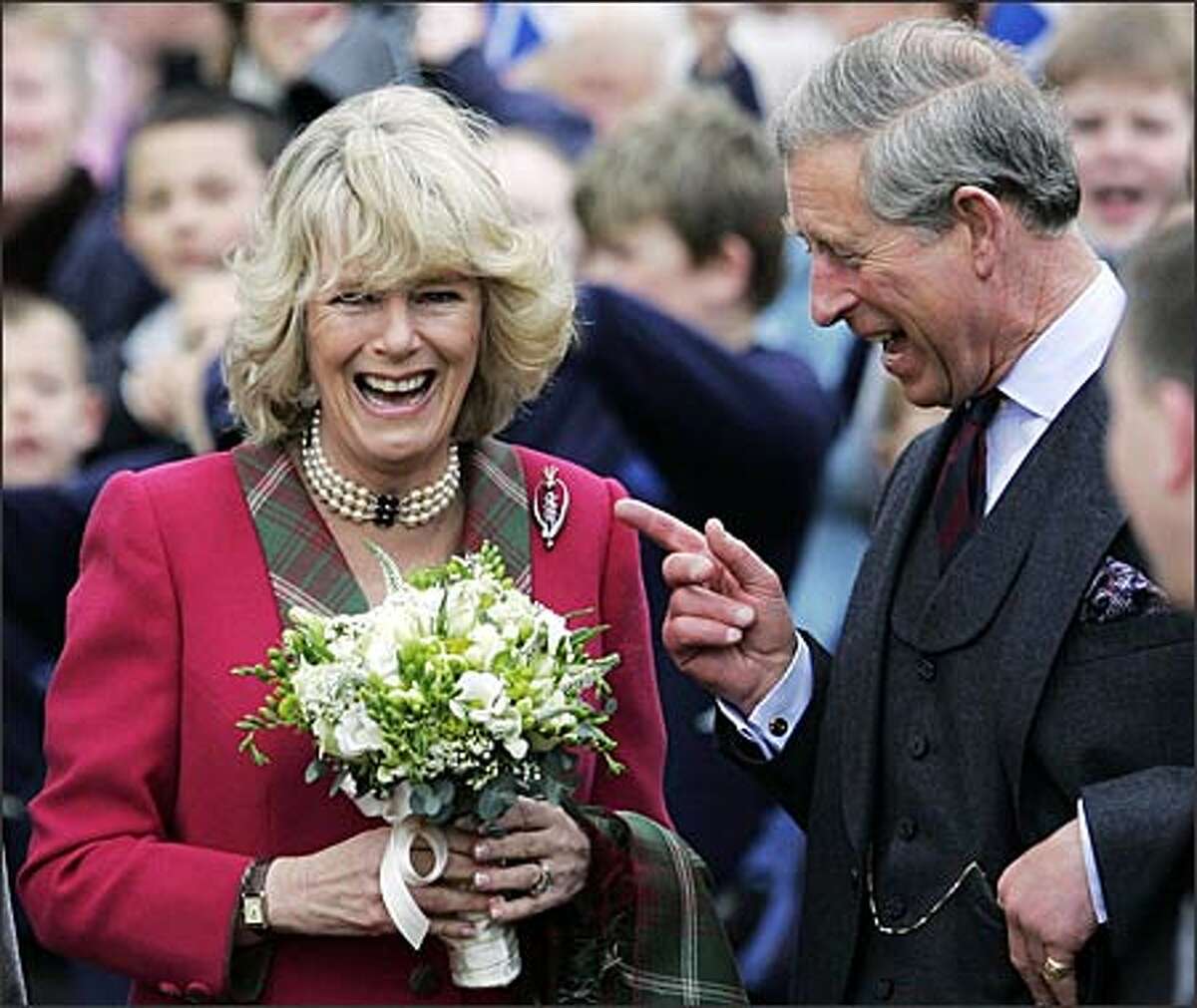 No matter how you feel about Camilla, duchess of Cornwall, you have to admit that she and the likely future king of England look happy together. She and Charles appeared at the opening of a new park in Scotland on Thursday -- their first public engagement since their marriage last Saturday. (ANDREW MILLIGAN/AP)