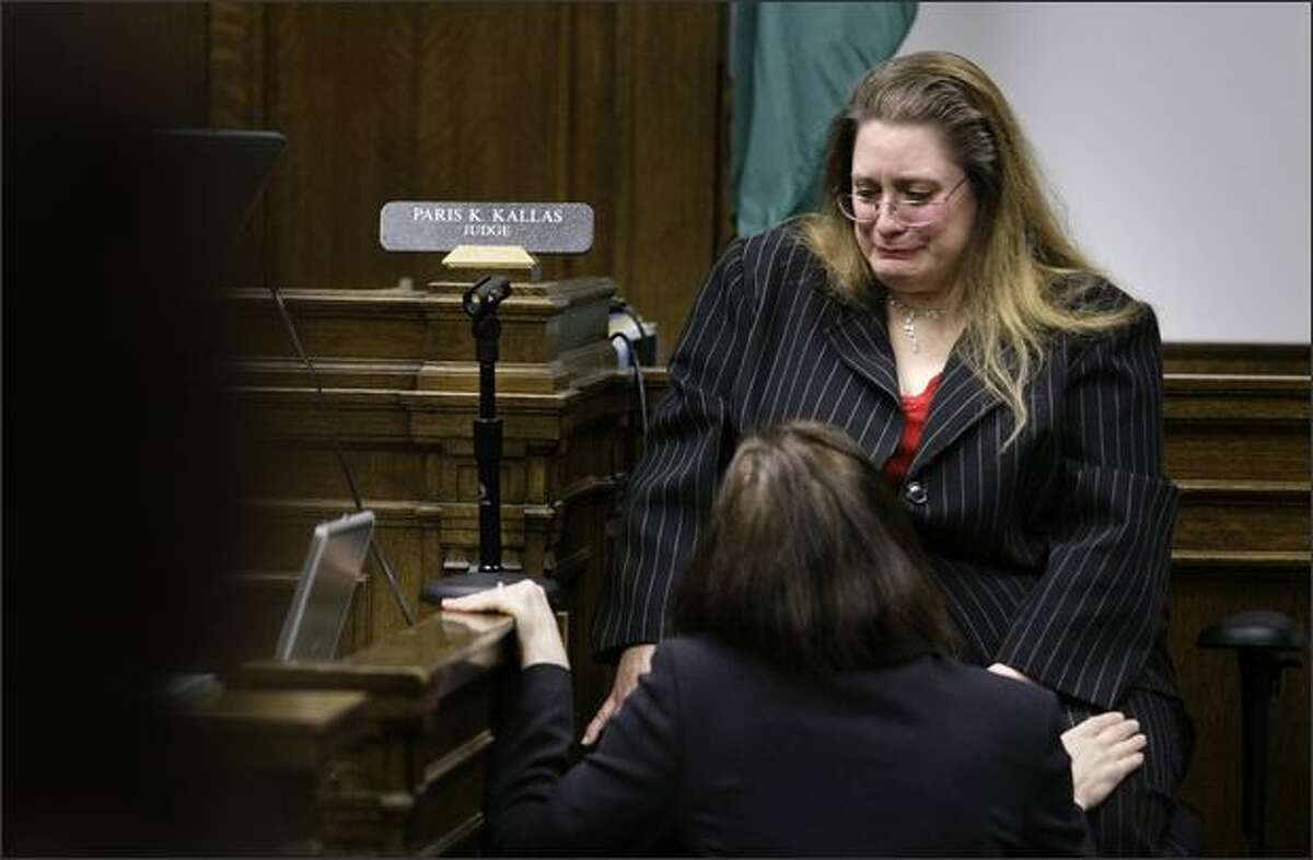 Christina Rexroad is consoled by her attorney as she gathers herself to continue her testimony in the trial of Naveed Haq.