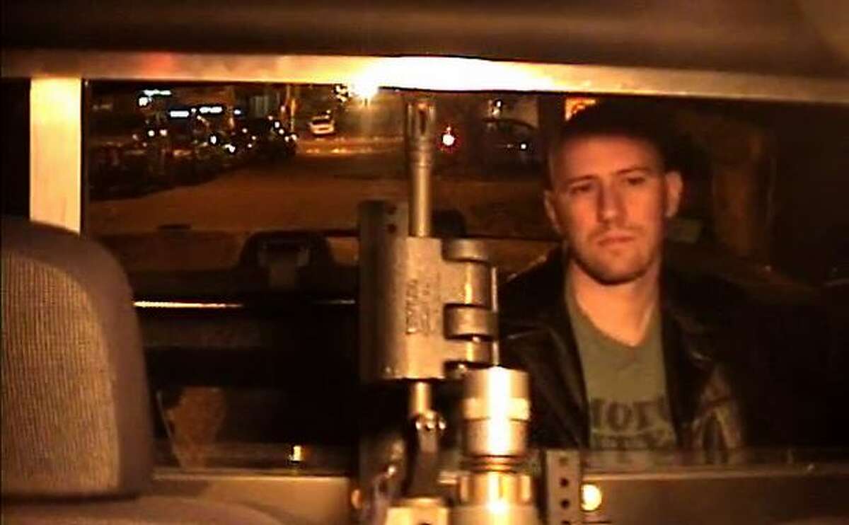 Eric Rachner sits in the back of a police car the night he was arrested for obstructing an officer. This image is taken from video footage recorded by a camera inside the vehicle -- footage that Seattle police long maintained could no longer be obtained. A computer security geek, Rachner spent long hours at his latpop sleuthing out what actually happened to the recordings.