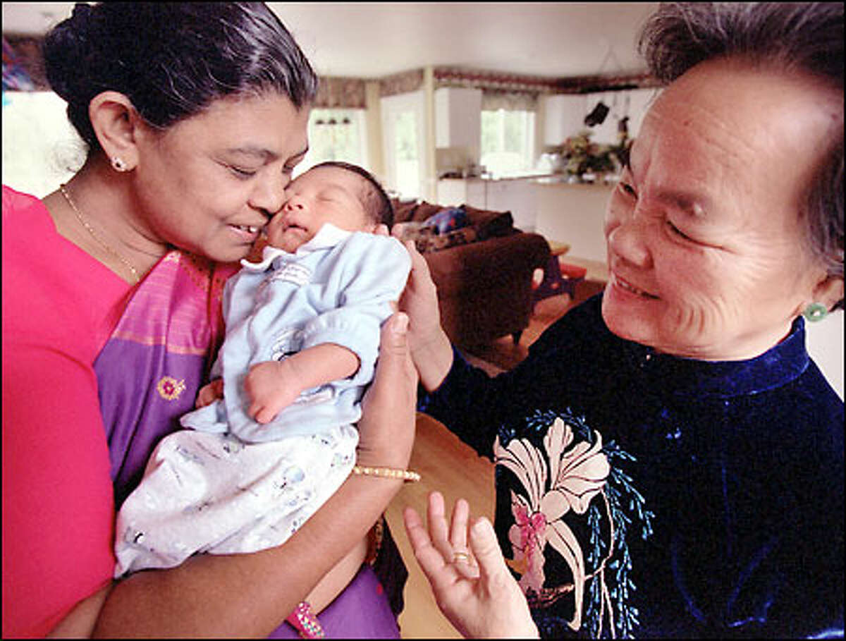 Alia Chaku Konukudy, left, from India and Pham Thi Giup from Vietnam traveled to the United States for the first time to see the birth of their grandson Nathan Hong.