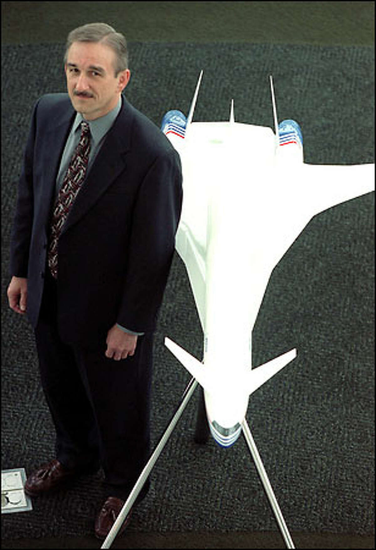 Tom Waggener, newly named director of marketing for The Boeing Co.'s sonic cruiser program, shows a model of the ultrafast jet. To aid in the development of the sonic cruiser, Waggener has been meeting a core group of about a dozen major airlines around the world that would be potential customers for the plane. "The major question is how the airlines would use this new plane," he says.
